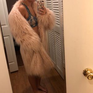 This is a long pink fur coat.